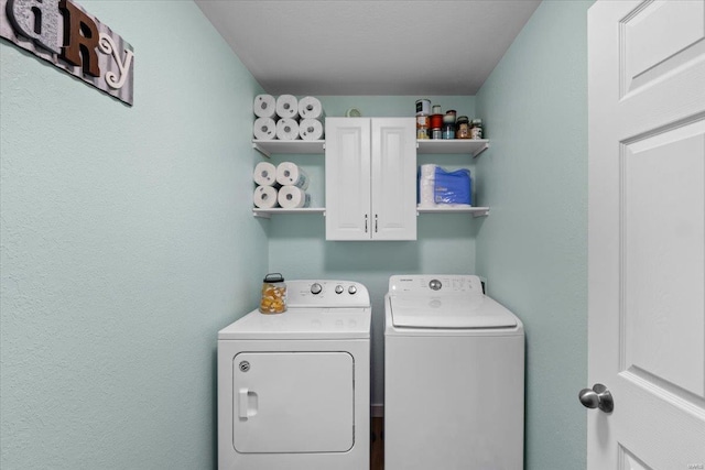 laundry area with cabinet space and washer and clothes dryer