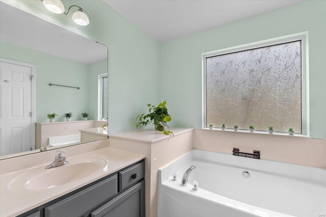 bathroom featuring a garden tub and vanity