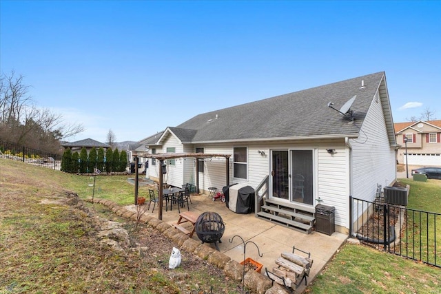 rear view of property featuring entry steps, a patio, an outdoor fire pit, fence, and a pergola