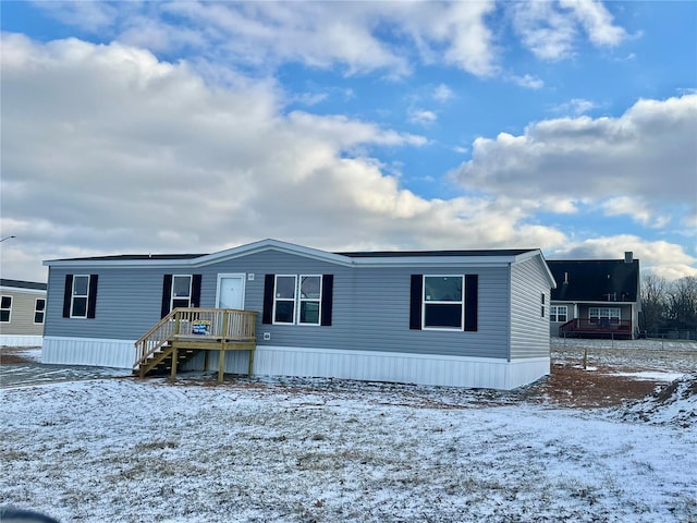 manufactured / mobile home featuring stairway and a wooden deck