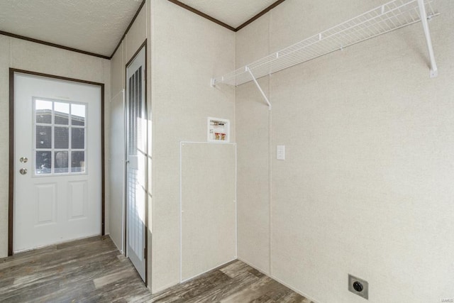 washroom with dark wood-style floors, ornamental molding, electric dryer hookup, a textured ceiling, and laundry area
