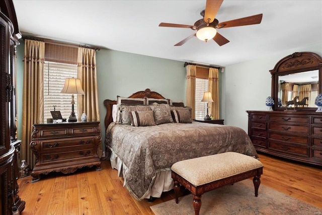 bedroom with light wood-style floors and a ceiling fan