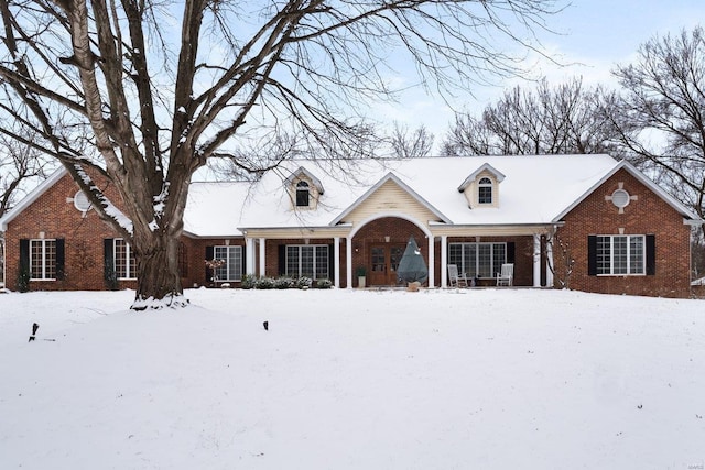 new england style home featuring brick siding