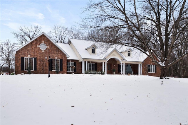 cape cod home with brick siding