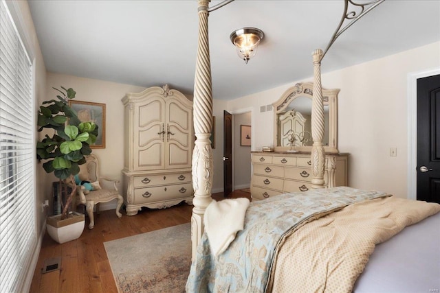 bedroom featuring visible vents and wood finished floors