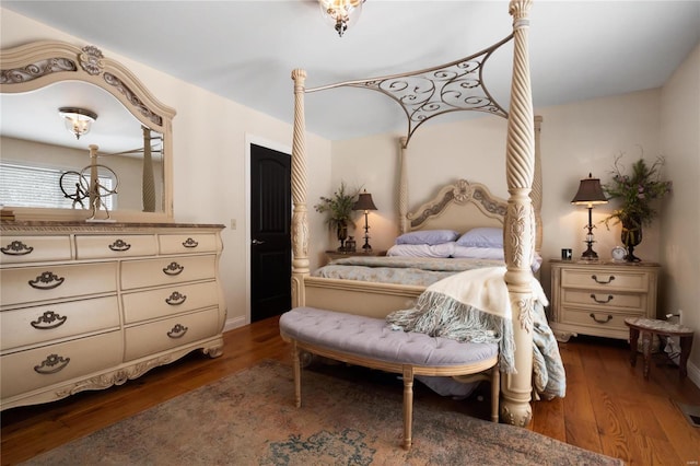 bedroom with dark wood-style flooring and baseboards