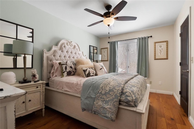 bedroom with dark wood-type flooring, a ceiling fan, and baseboards