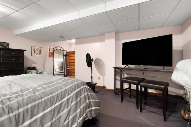 bedroom featuring carpet, baseboards, and a drop ceiling