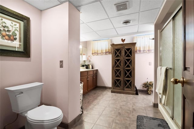 bathroom featuring a paneled ceiling, visible vents, toilet, and vanity