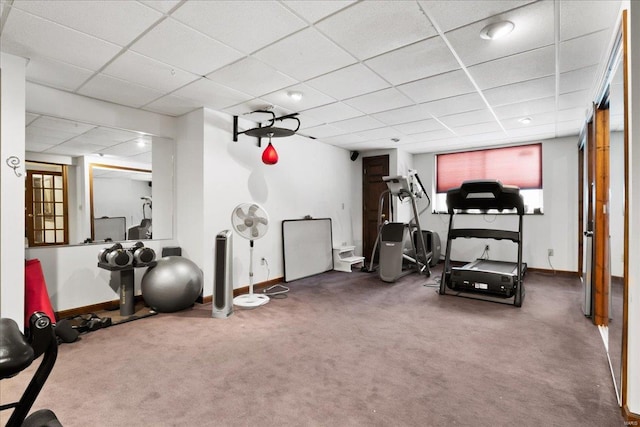 workout room with carpet floors, a drop ceiling, and baseboards