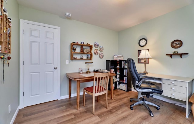 office with light hardwood / wood-style flooring