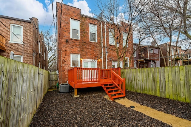 rear view of house featuring central AC and a deck