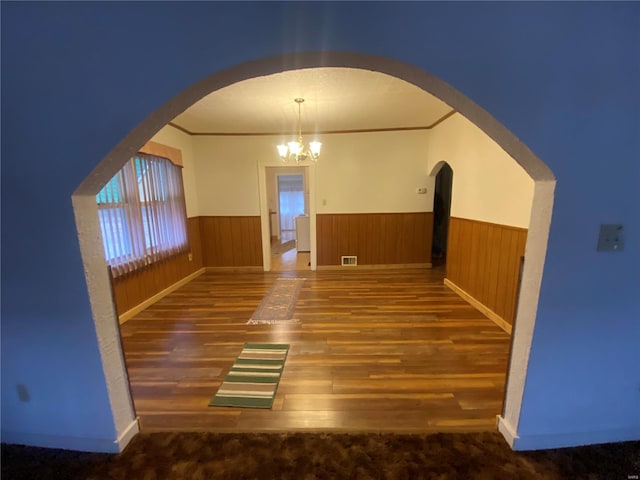 interior space with crown molding, dark hardwood / wood-style floors, and a chandelier