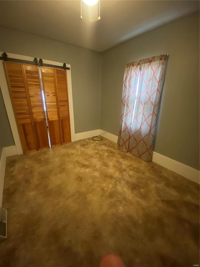 unfurnished bedroom featuring carpet flooring and ceiling fan