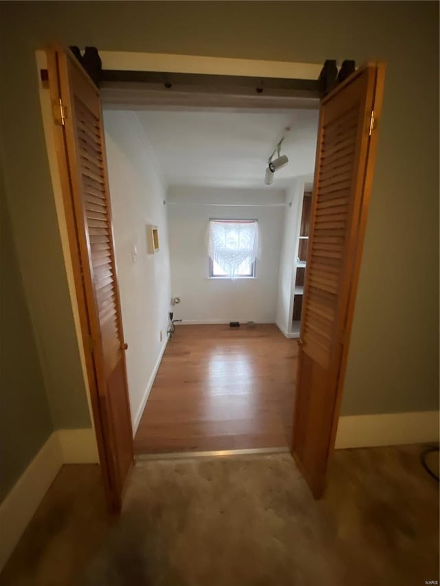 corridor with hardwood / wood-style flooring