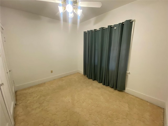 unfurnished room featuring ceiling fan and light colored carpet