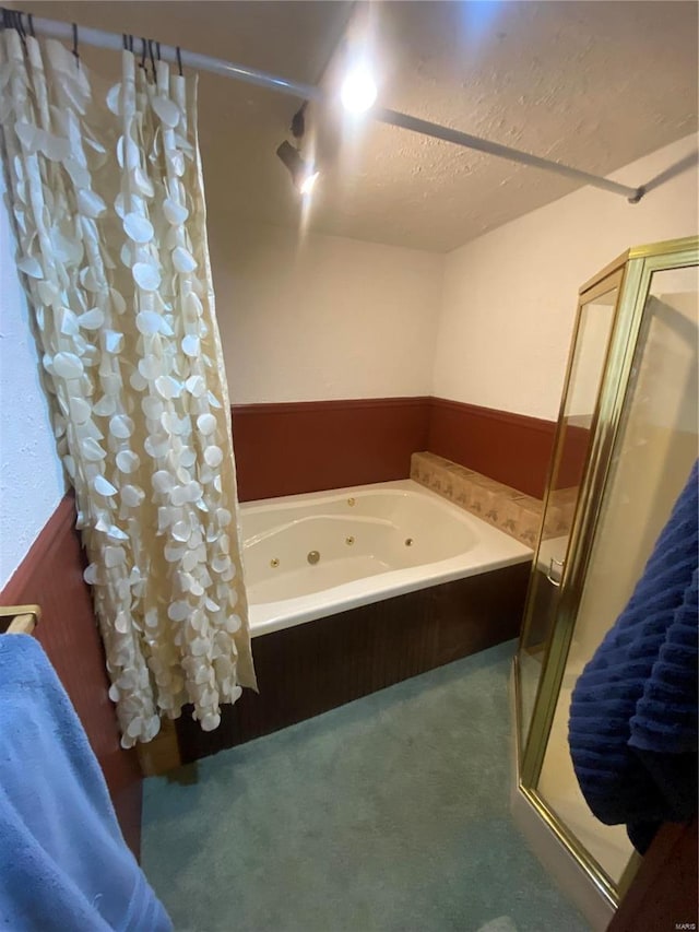 bathroom with separate shower and tub and a textured ceiling