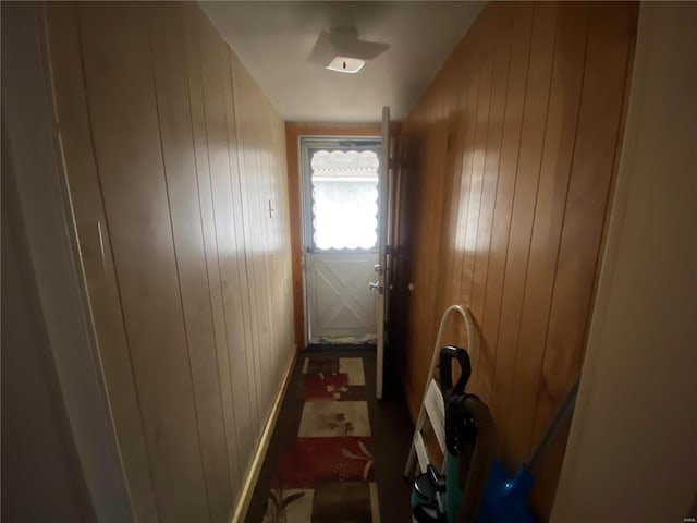 doorway with wooden walls