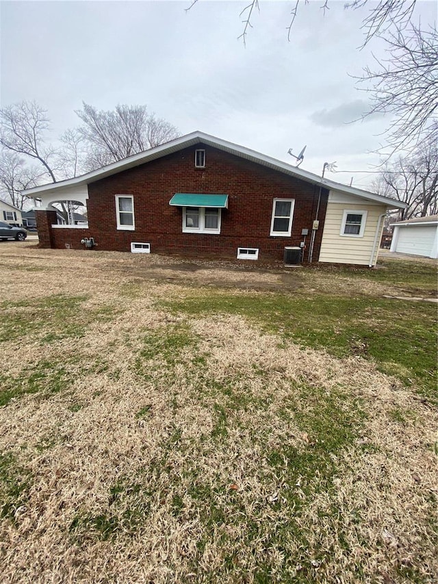 back of property featuring a lawn