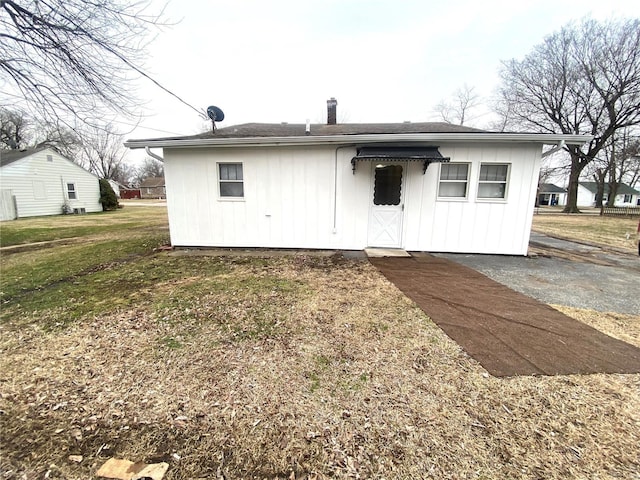 rear view of house with a yard