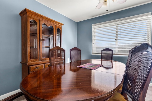 dining area with ceiling fan and baseboards