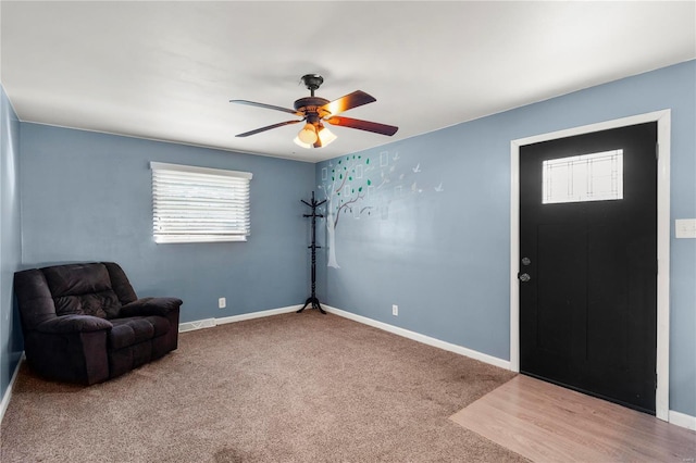 sitting room featuring ceiling fan, carpet flooring, and baseboards