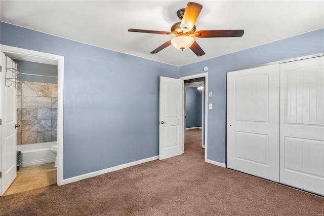 unfurnished bedroom featuring ensuite bath, carpet, baseboards, and a closet