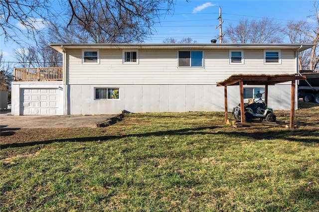 rear view of property with a garage and a lawn