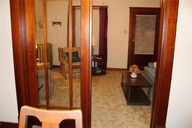 hallway with light carpet and baseboards