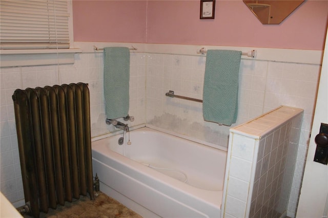 full bathroom with a garden tub, radiator heating unit, and tile walls