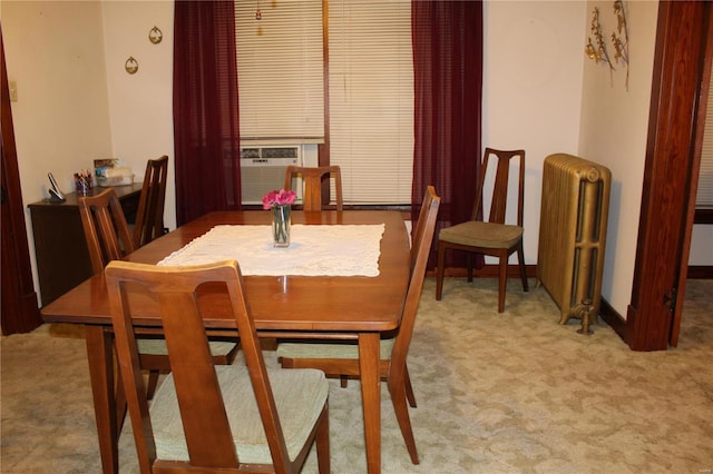 dining room featuring light carpet, radiator heating unit, and cooling unit