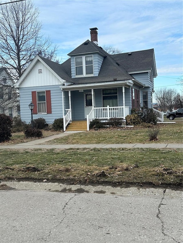 bungalow-style house with a front lawn and a porch