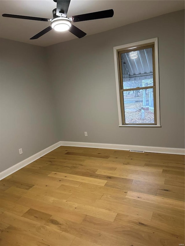 empty room featuring ceiling fan and light hardwood / wood-style floors