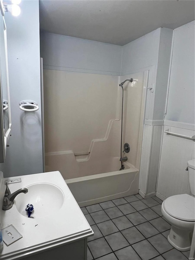 bathroom with toilet, shower / tub combination, tile patterned flooring, and vanity