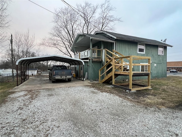 view of front of home with gravel driveway and a carport