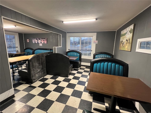 dining area featuring a textured ceiling and tile patterned floors