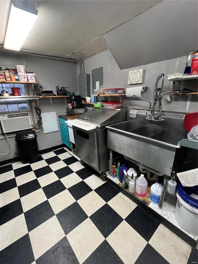 kitchen with dark floors, dark countertops, open shelves, and electric panel