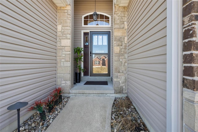 entrance to property featuring stone siding