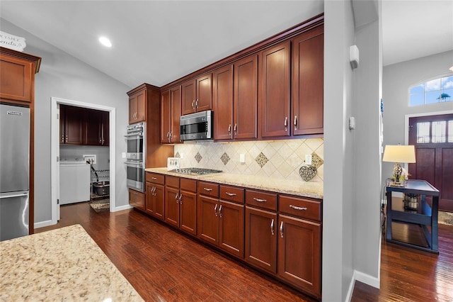 kitchen featuring light stone countertops, tasteful backsplash, stainless steel appliances, and dark wood-style flooring