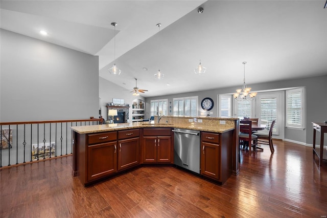 kitchen with stainless steel dishwasher, an island with sink, a sink, and pendant lighting