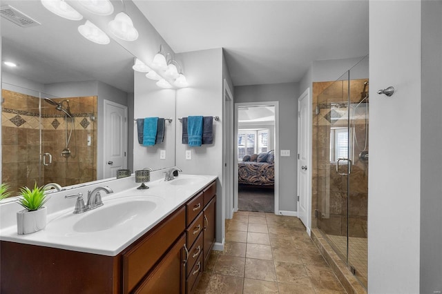 ensuite bathroom featuring a shower stall, visible vents, a sink, and ensuite bathroom