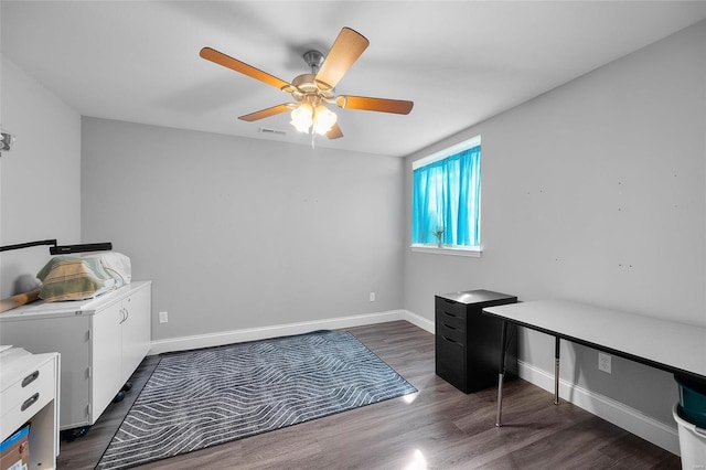 office space featuring dark wood-style flooring, visible vents, and baseboards