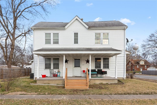 view of front of property with central AC, a porch, and a front lawn