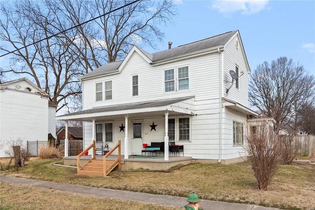 view of front of house featuring covered porch and a front lawn