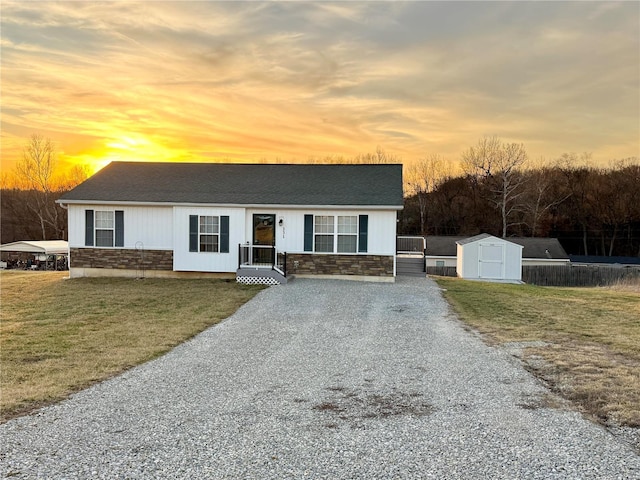 ranch-style home with a yard and a shed