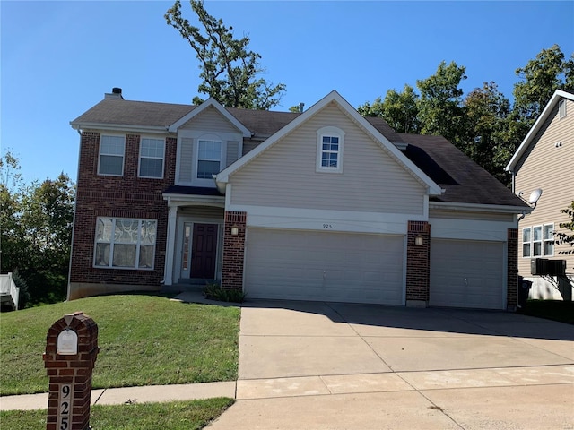 view of front of house featuring a garage and a front lawn