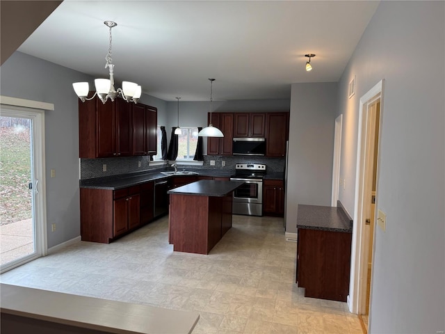 kitchen featuring tasteful backsplash, sink, hanging light fixtures, a center island, and stainless steel appliances