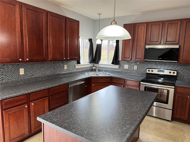 kitchen with pendant lighting, sink, stainless steel appliances, a center island, and decorative backsplash