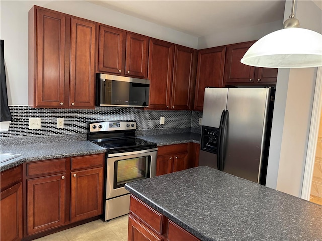 kitchen with stainless steel appliances, decorative light fixtures, and decorative backsplash