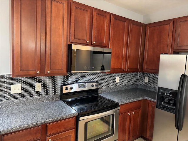 kitchen featuring stainless steel appliances and tasteful backsplash